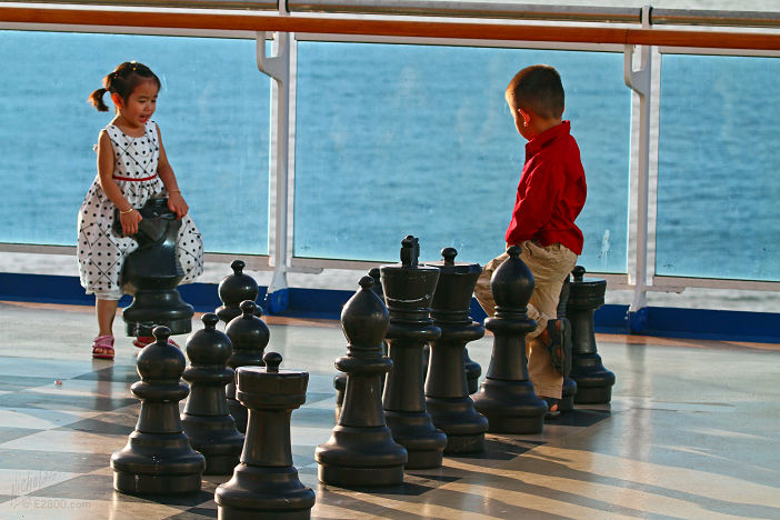 Children playing chess on a cruise ship