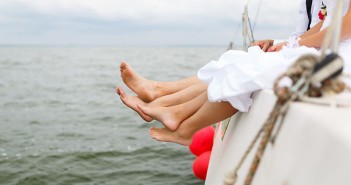 Legs of newlyweds on a yacht at the summer time