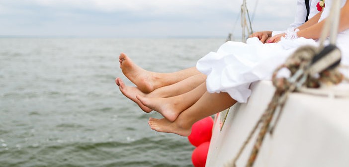 Legs of newlyweds on a yacht at the summer time