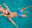 couple floating in pool