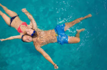 couple floating in pool