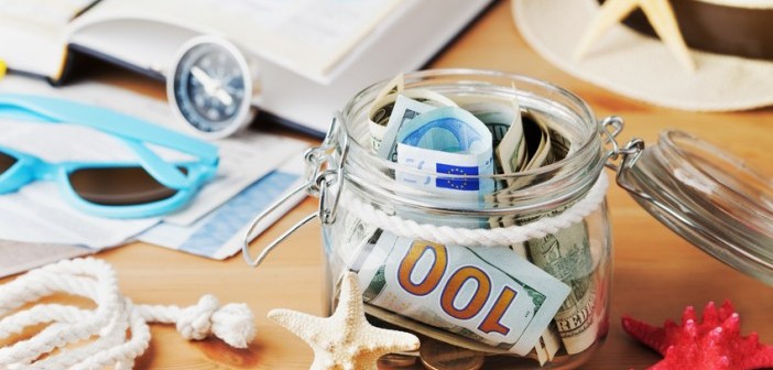 sea shells, sunglasses and maps with a jar of foreign euro currency