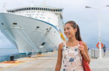 Cruise ship passenger leaving boat for shore excursion in harbour. Asian woman tourist spending a day in port of call of Caribbean travel destination.
