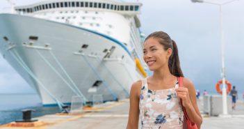 Cruise ship passenger leaving boat for shore excursion in harbour. Asian woman tourist spending a day in port of call of Caribbean travel destination.