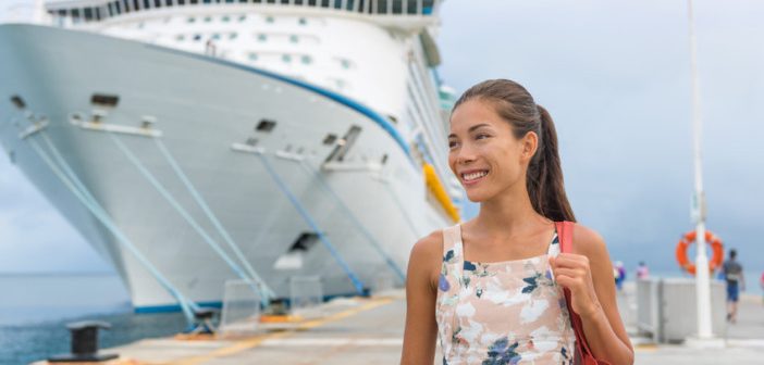 Cruise ship passenger leaving boat for shore excursion in harbour. Asian woman tourist spending a day in port of call of Caribbean travel destination.