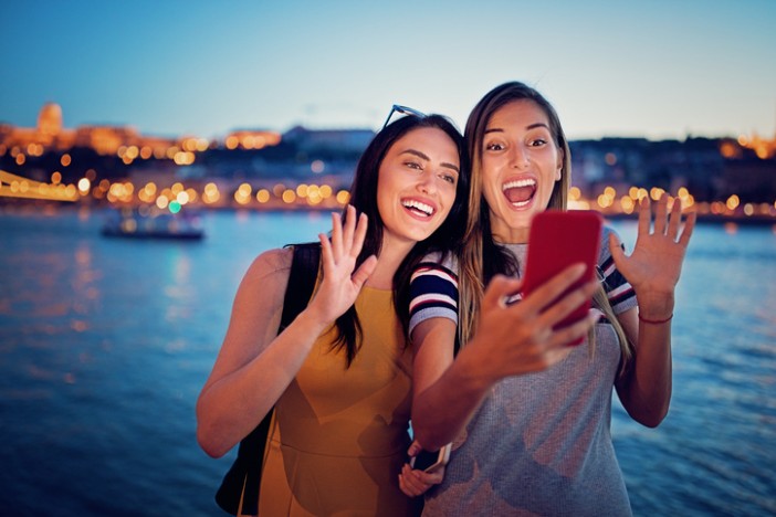 Women make phone video call on a cruise holiday | Cruise1st Australia
