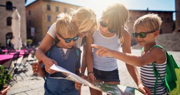 Kids on holiday checking tourist information