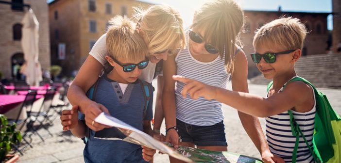 Kids on holiday checking tourist information