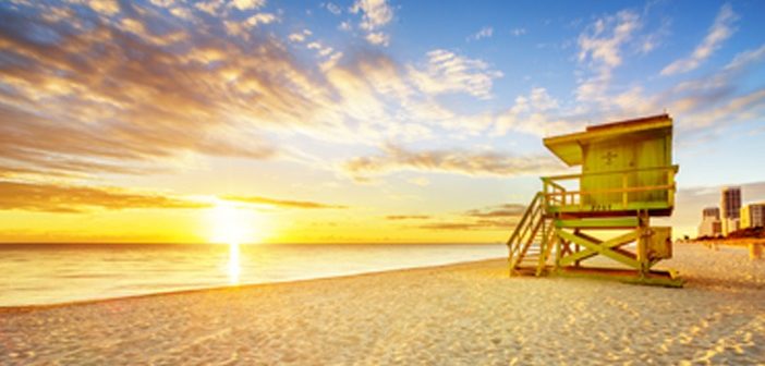 beach sunset with lifeguard tower in the foreground