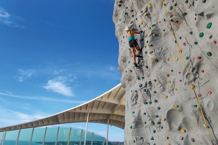 a woman rock climbing on a cruise ship