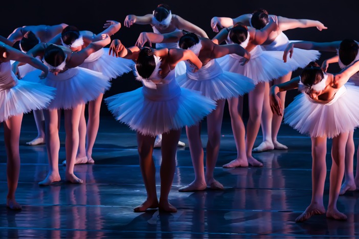 Ladies dressed in white dancing ballet