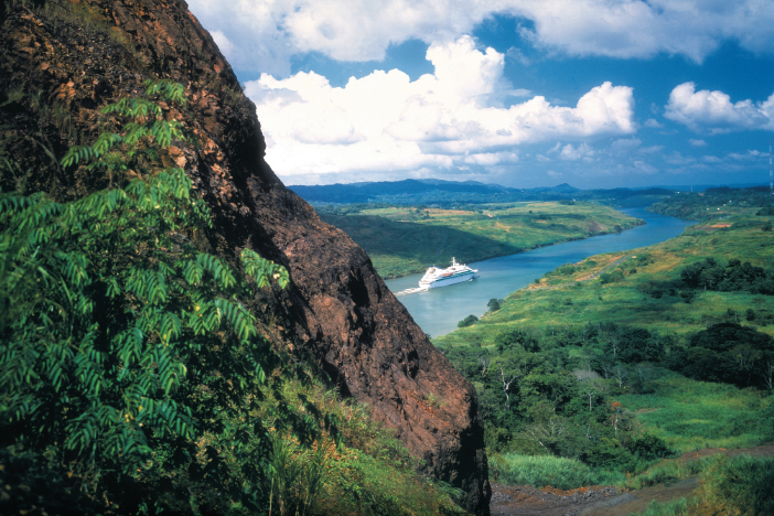 luxury cruise ship sailing lush greenery