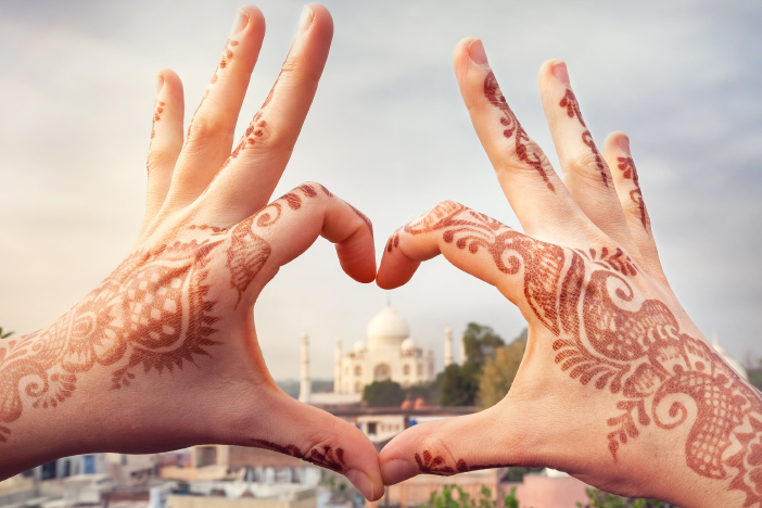 henna hands in heart with the Taj Mahal in the background